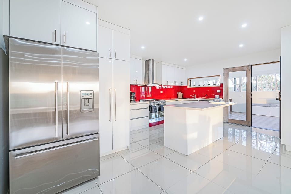 Prepare everything from relaxed breakfasts to family feasts in the contemporary kitchen, thoughtfully designed with generous bench space, premium appliances, and a practical open layout.