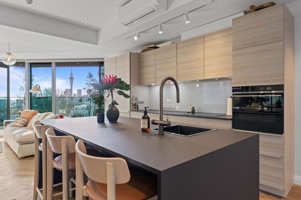 Sleek open-plan kitchen with a generous island, modern appliances and breakfast-bar seating