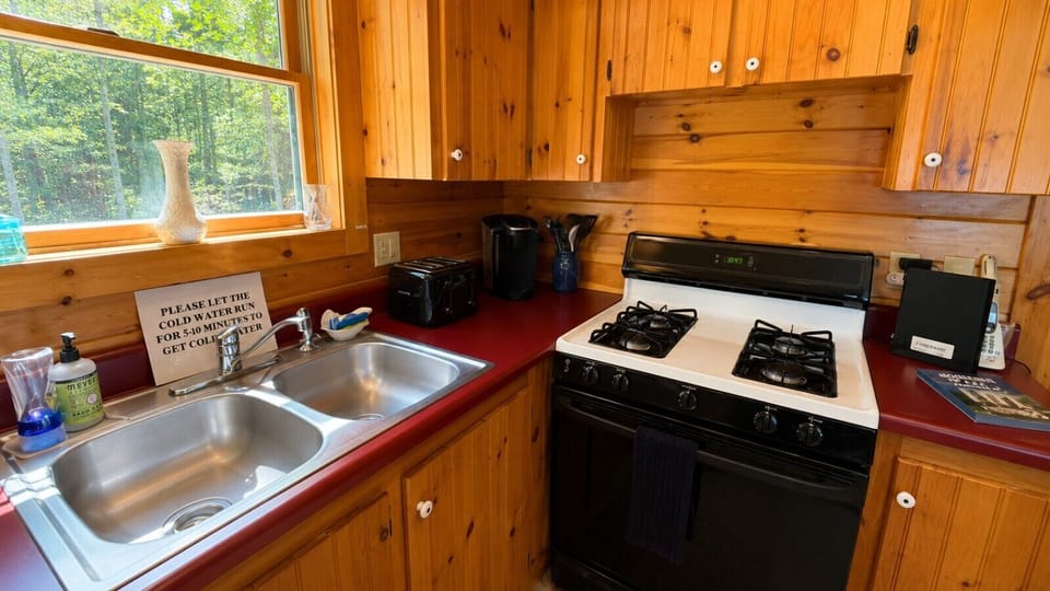 Fully equipped kitchen with a gas stove, plenty of counter space, and warm wood interiors.