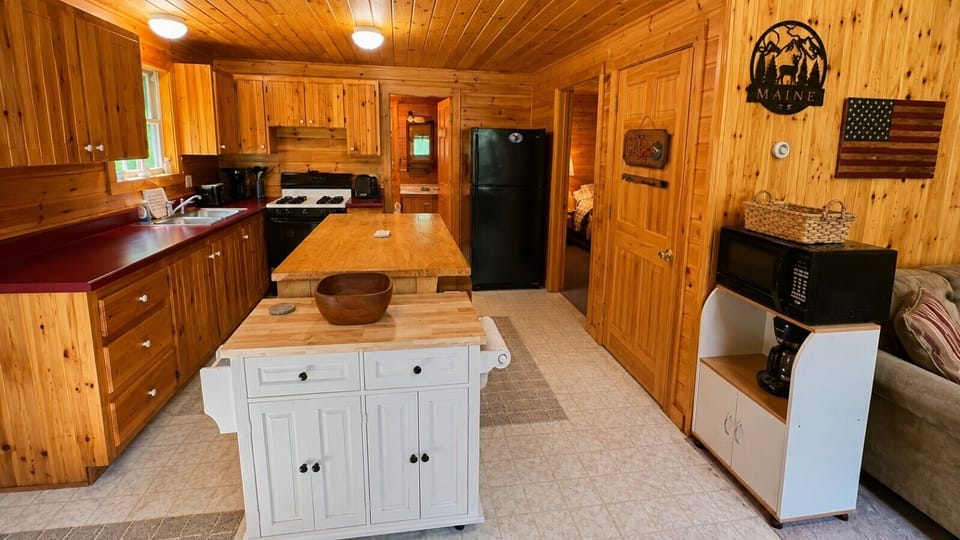 Rustic kitchen with warm wood finishes, plenty of counter space, and a convenient center island.