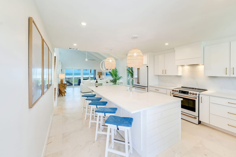 A gourmet kitchen boasts a spacious island, complemented by stylish lighting and modern appliances.