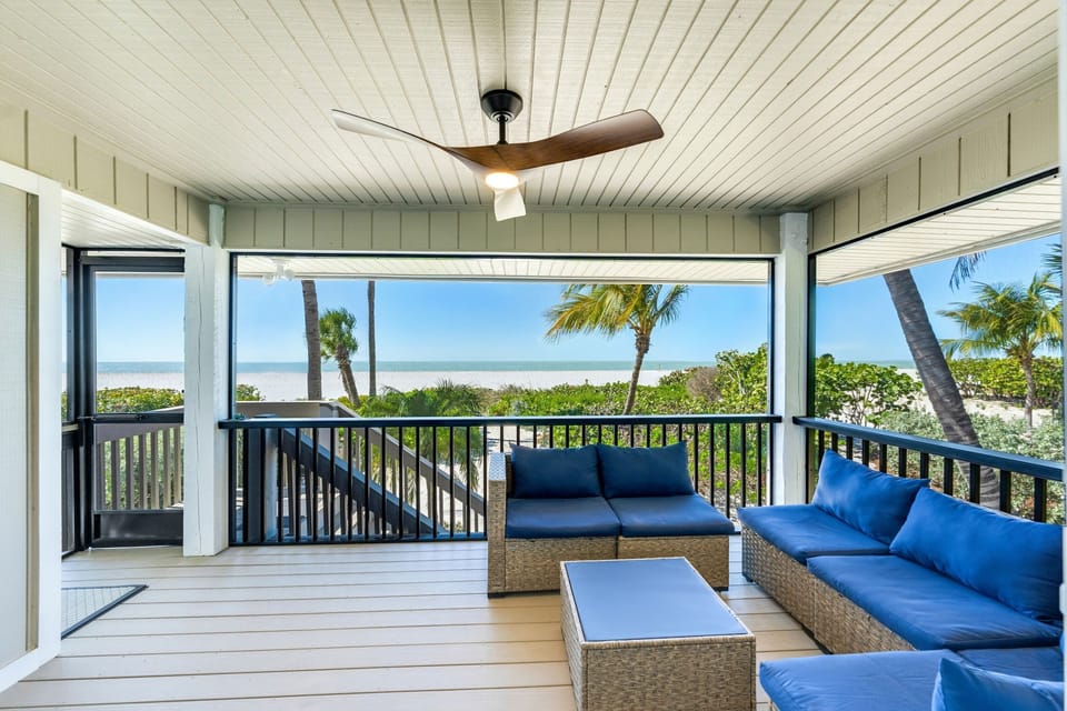 A cozy screened-in lanai offers tranquil water views, perfect for relaxing in gentle breezes.