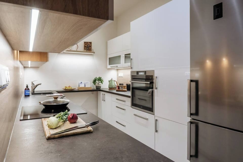 Cook like at home in the modern kitchen with Nespresso, oven, and dishwasher. Everything you need for a cozy breakfast or a homemade dinner after a day in Prague.