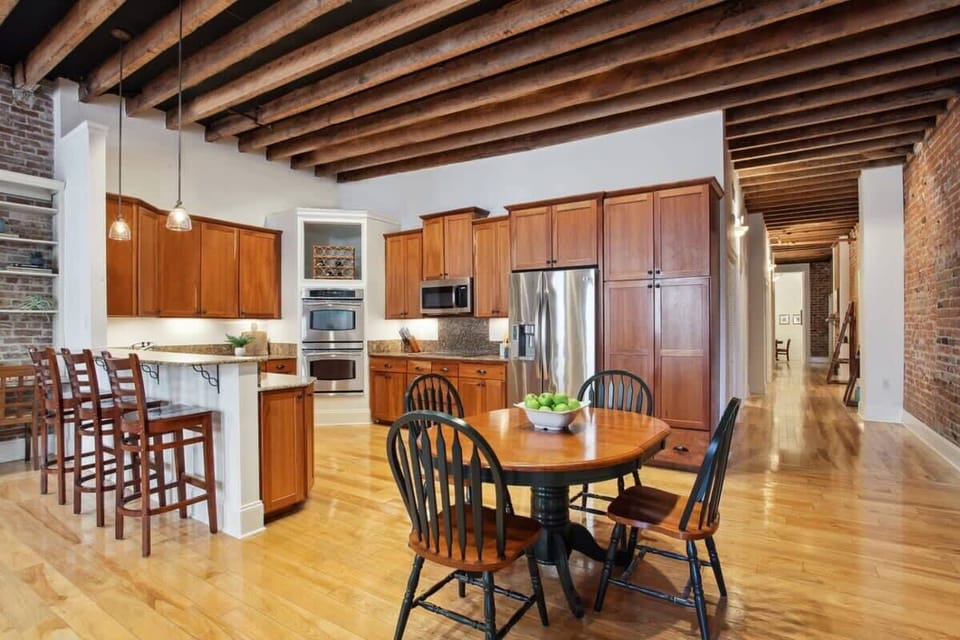 Kitchen | Fully Stocked Kitchen with Island and Bar Seating | Third Floor of Building — Unit on One Level