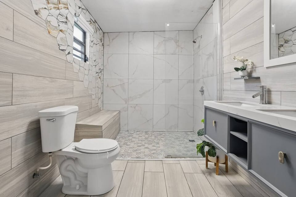 Spa-style bathroom with walk-in glass shower and sleek double vanity