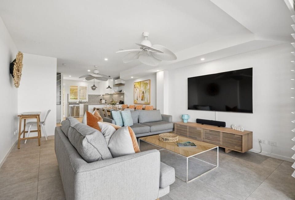 Open plan dining and living area with balcony access and outdoor dining