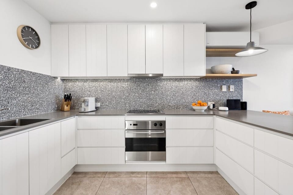 Fully equipped kitchen with island bench and Nespresso coffee machine