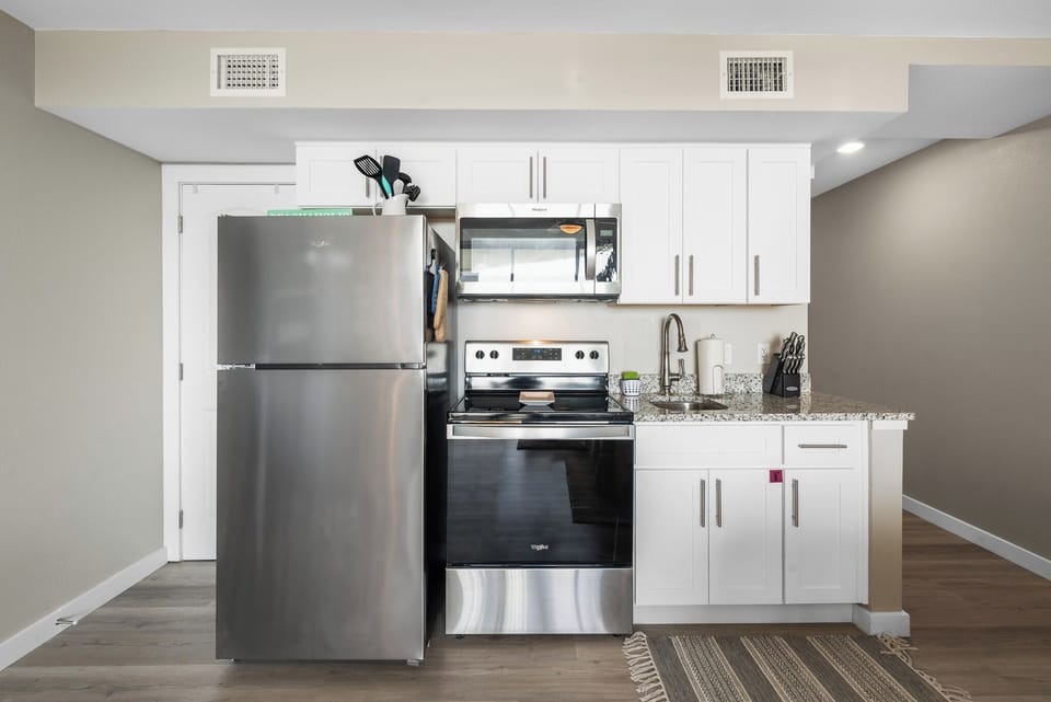 Full size fridge and range with all the necessary utensils, dishes, wine glasses and pots and pans you will need