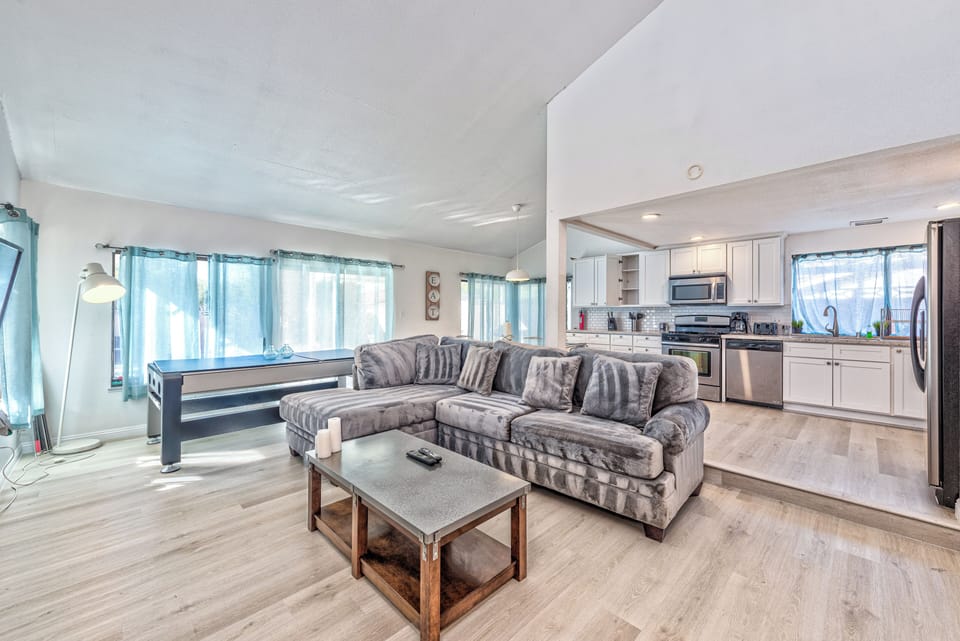 Bright open living space with cozy sectional and modern kitchen