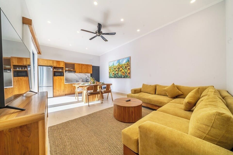 Living Room: Bright, airy space with stylish seating and a charming view of artful sunsets!