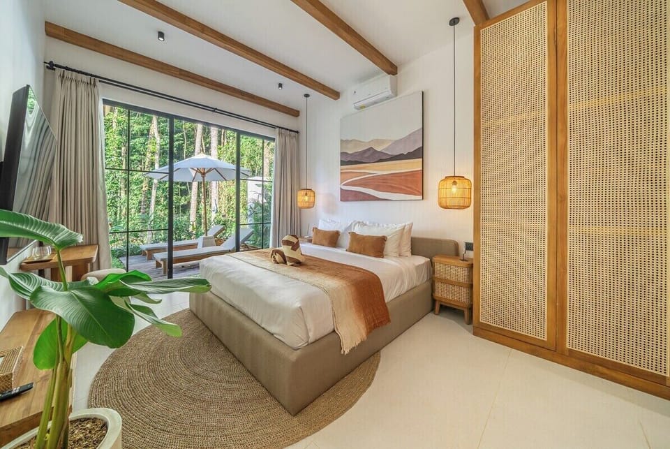 Luxurious Bedroom Retreat: Embrace nature with stunning views, warm tones, and chic decor!