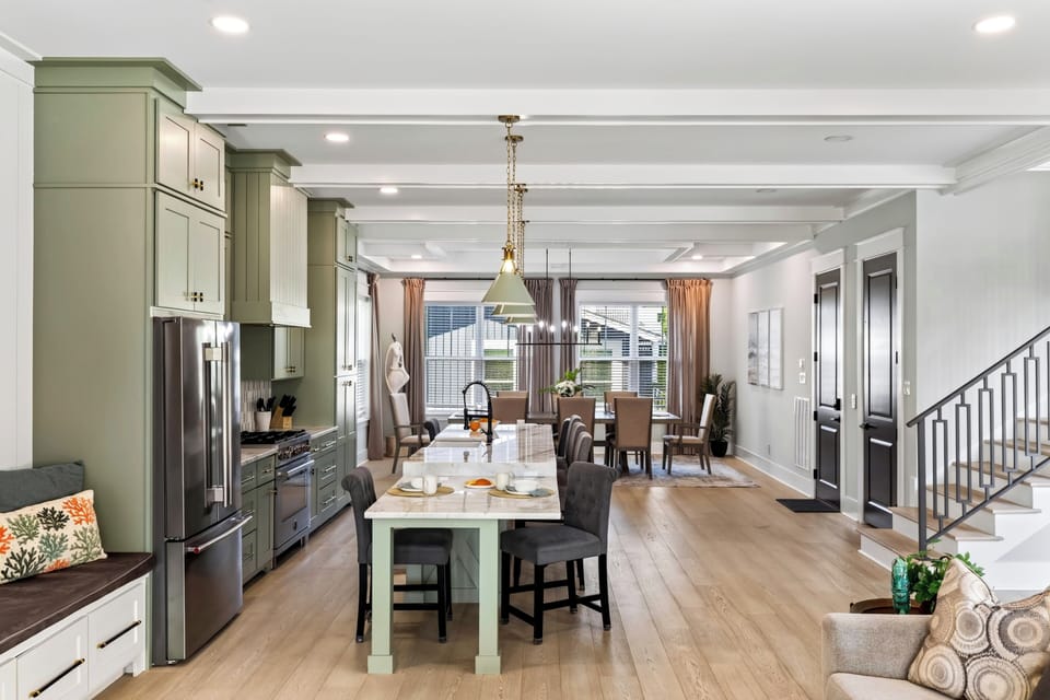 A spacious open layout connects the kitchen, island seating, and dining area, giving the group plenty of room to cook, dine, and gather.