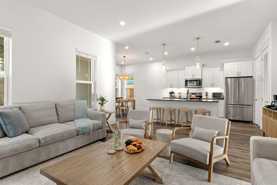 An airy open-concept living space flows into the modern kitchen and dining area, making it easy for everyone to gather together.