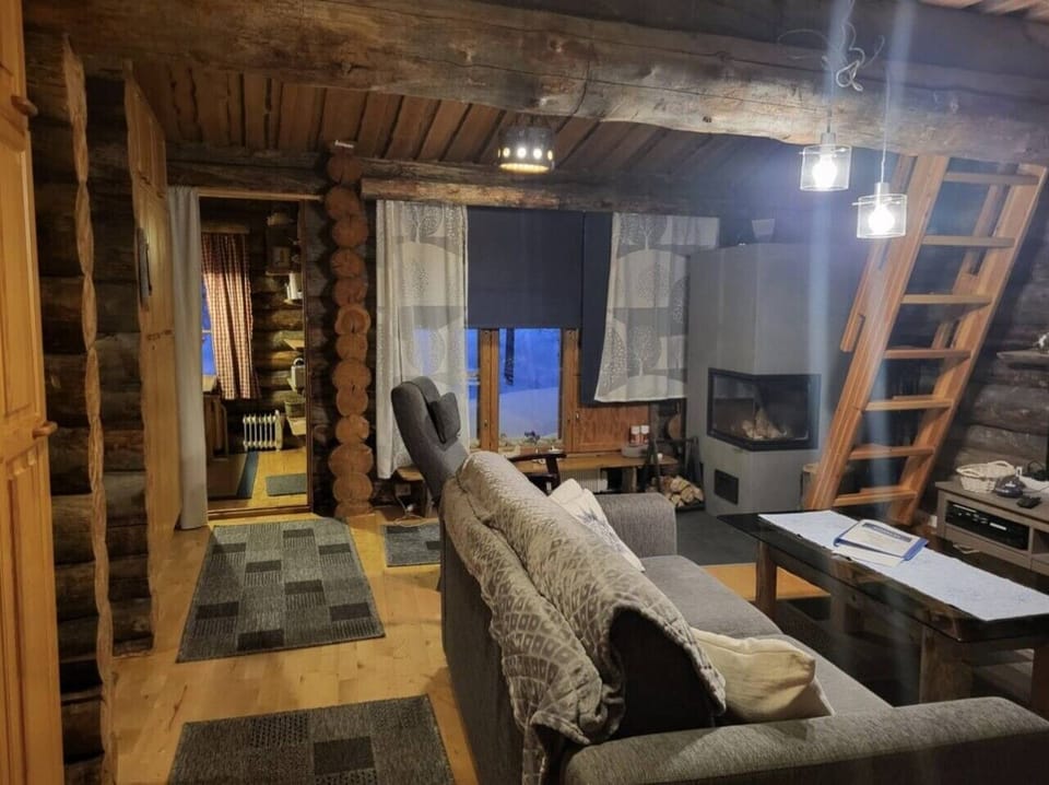 Living room with a fireplace and stairs leading up to the loft.