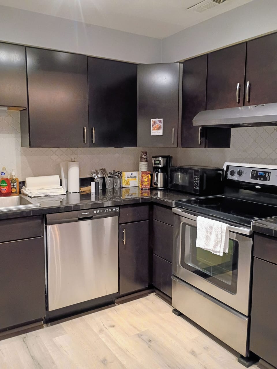 microwave, kitchen visible, indoor, coffee maker, kitchen, oven, stovetop