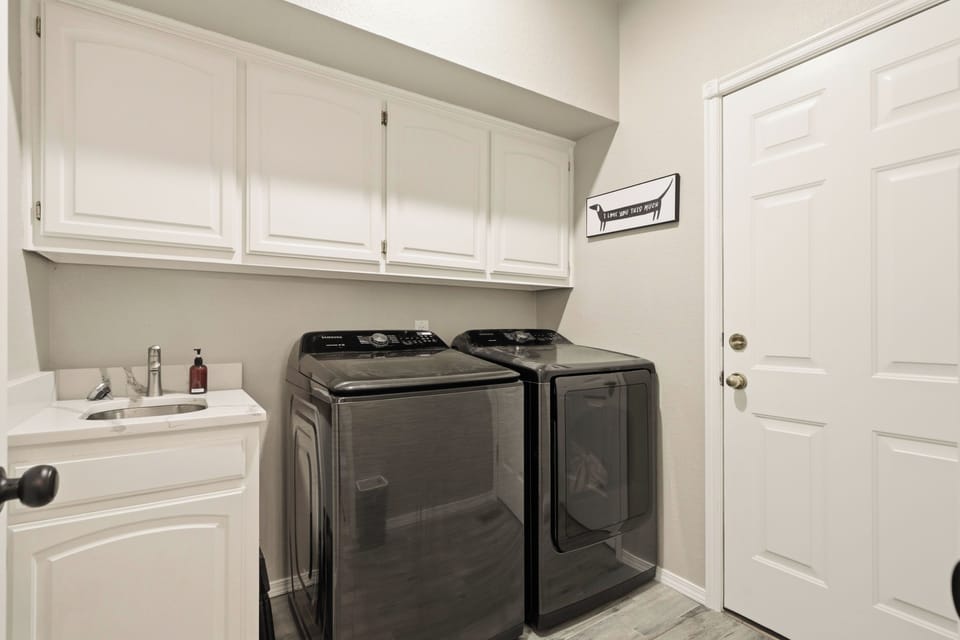 Spacious laundry room with sink. We provide detergent, fabric softener and dryer sheets for your use.