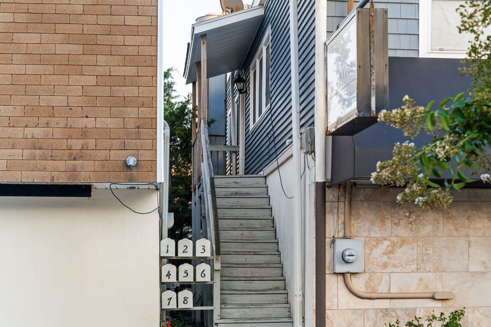 Head up the exterior staircase to reach the apartment entrance.