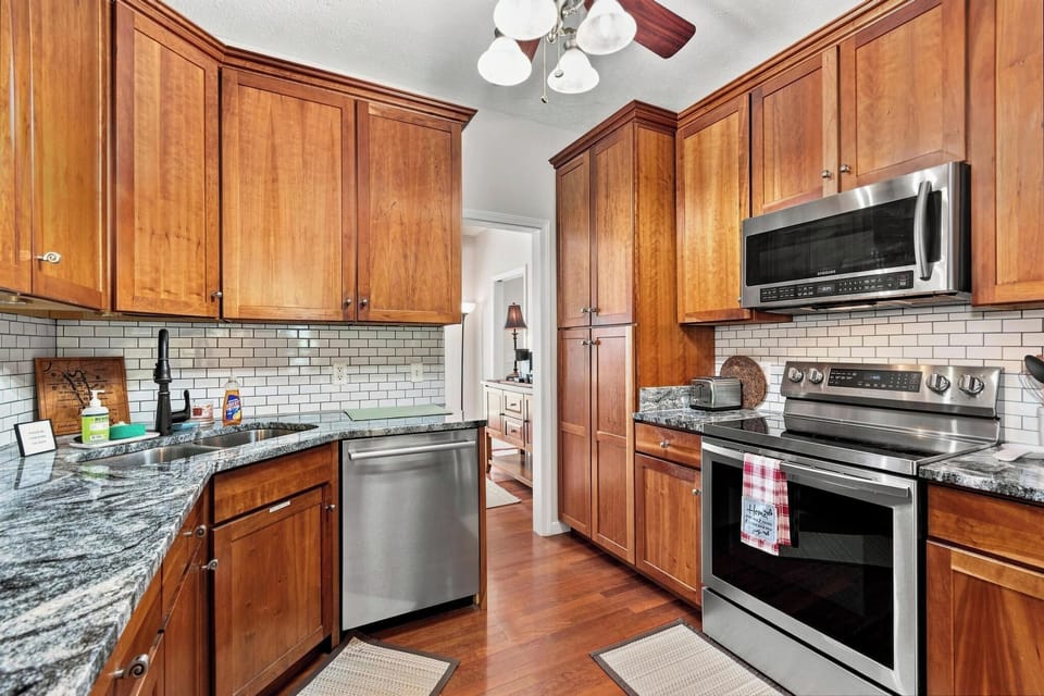 The kitchen is equipped with stainless steel appliances and ample counter space.