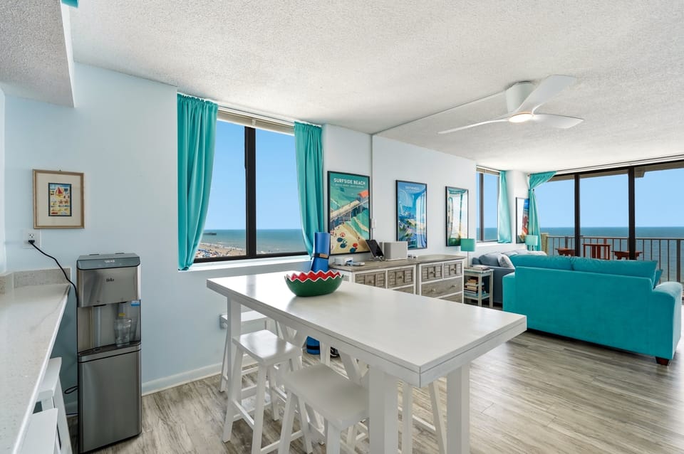 Soak in those stunning coastal views from your bright, beachy living space. With turquoise accents echoing the sea beyond your windows, you'll feel the ocean breeze the moment you step inside.