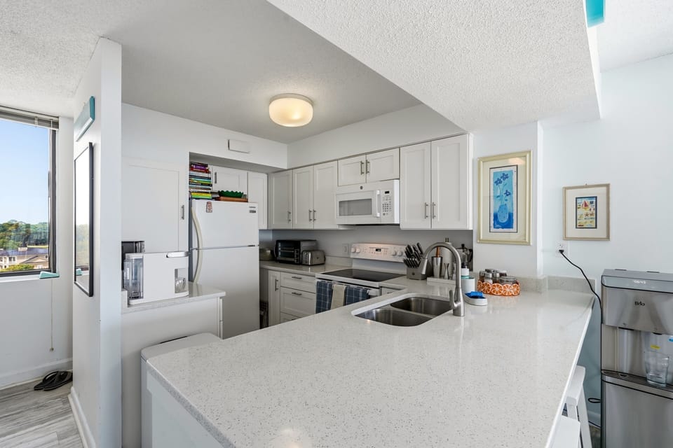 Your open kitchen invites you to whip up meals with modern appliances and sleek countertops. Natural light pours in from the windows, brightening the space while you cook and gather with loved ones.