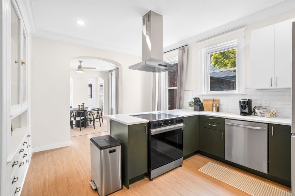 Bright, fully equipped kitchen with modern appliances and an open view toward the dining room.