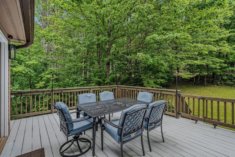 Furnished deck for outdoor dining among the trees