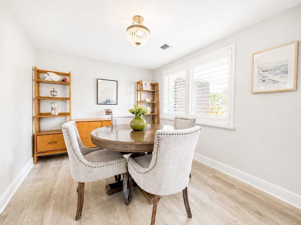Bright dining nook with chic seating, natural light, and elegant decor