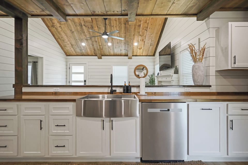 Rustic-modern kitchen with farmhouse sink and stunning wood beam ceiling