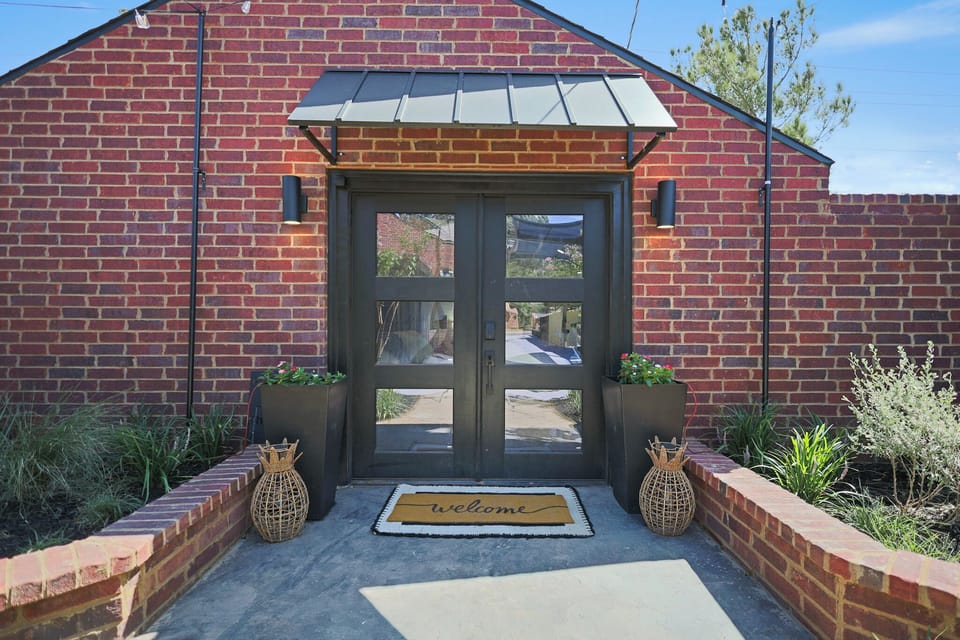 Inviting brick entry with modern double doors and stylish curb appeal