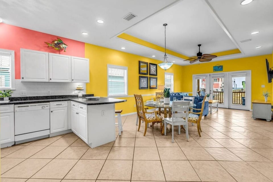 Open the French doors and let the Gulf breeze flow through your sun-soaked dining space.