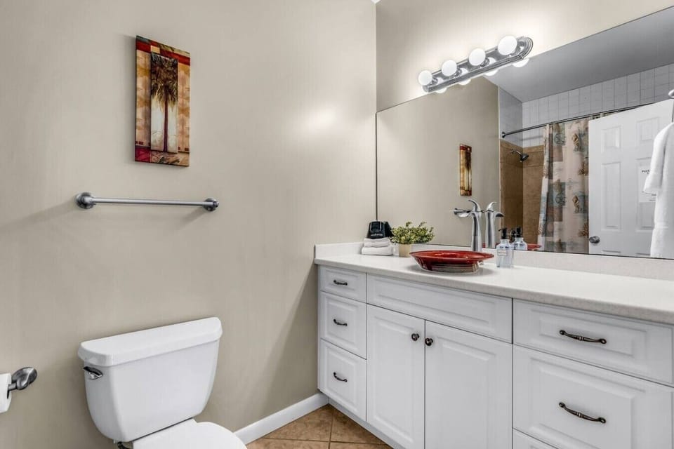 Bright lighting and a stunning vessel sink turn every bathroom moment into a spa experience.