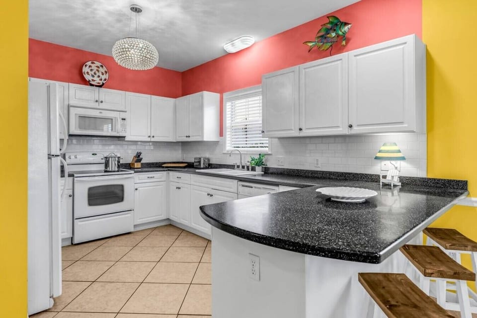 A fully stocked kitchen with bar seating makes cooking in feel like a vacation too.