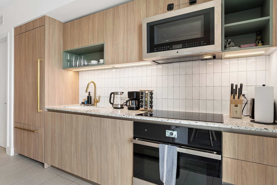 Sleek modern kitchen featuring built-in appliances, with all the essentials for your meals