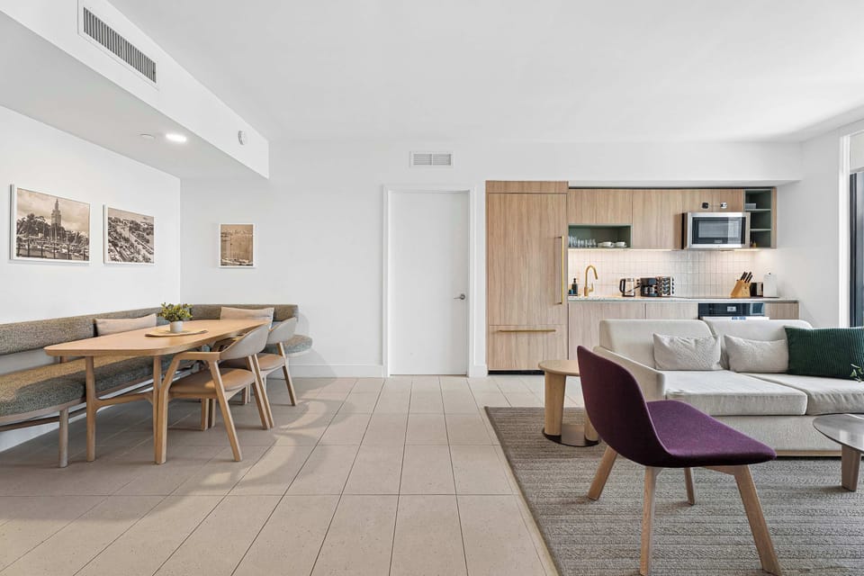 Spacious layout connecting the dining nook, kitchen, and main lounge space.