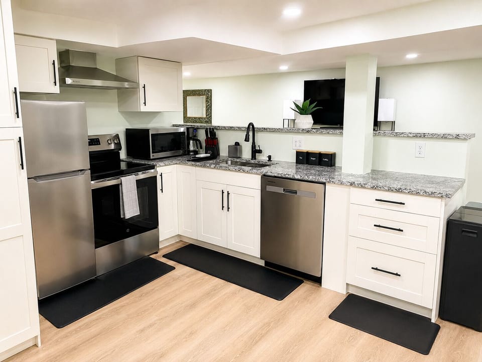 Kitchen on the lower level, equipped with cooking essentials and condiments.