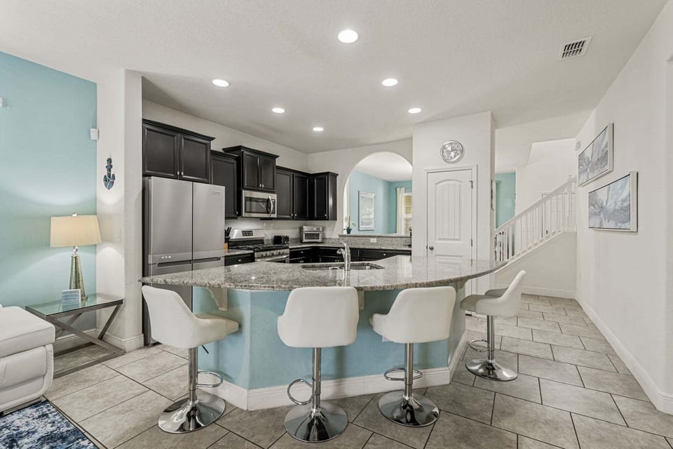 Kitchen Area w/ Large Island and Stainless-steel Appliances