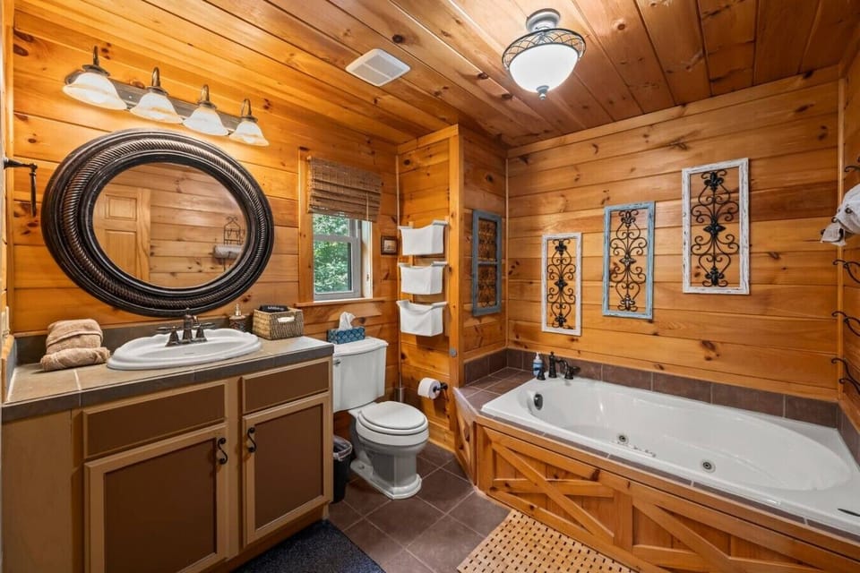 Located on the 2nd floor; a spa‑style bath with a tiled walk‑in shower (dual shower heads!), glass enclosure, bench seating, and a relaxing jacuzzi tub—your private mountain oasis.