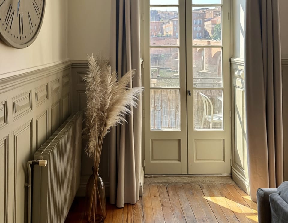 Sunlit French doors and classic details with charming balcony views