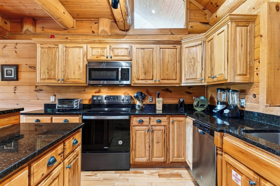 A warm wood kitchen pairs generous counter space with a center island and bar seating for casual meals and easy prep.