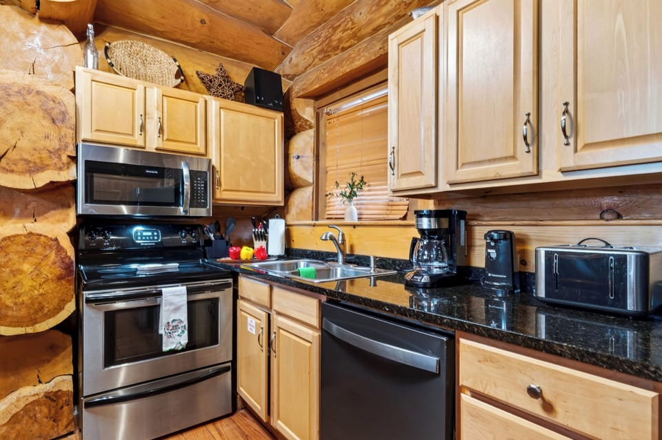 Fully equipped kitchen with stainless steel appliances.