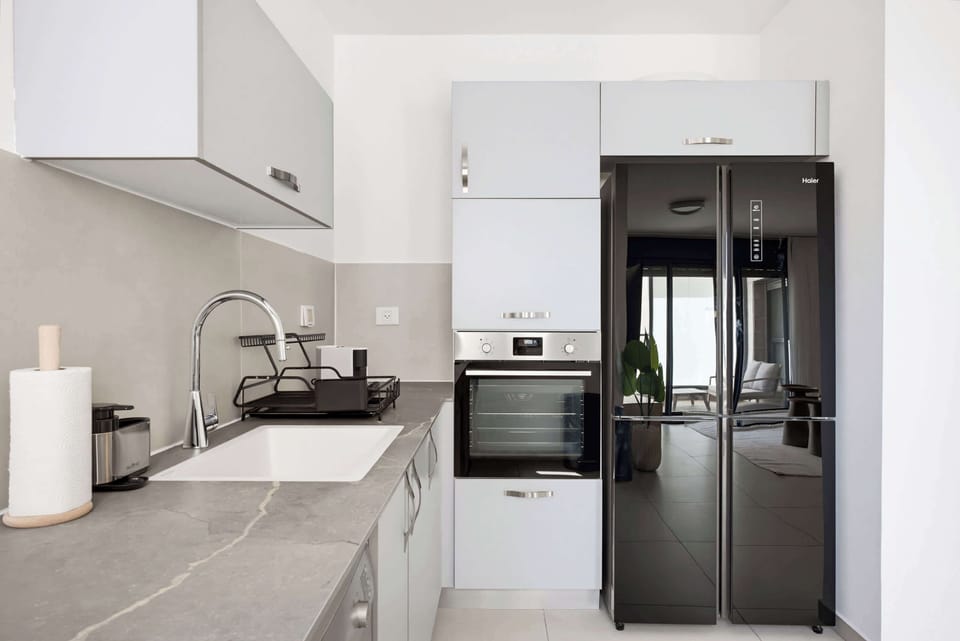 Cook effortlessly in this sleek kitchen, complete with a contemporary dishwasher and a standard oven.