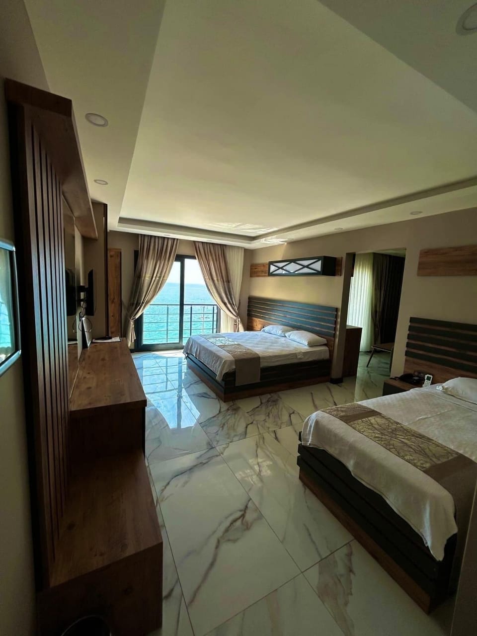Luxury Suite, Balcony, Sea View | Minibar (free items), desk, laptop workspace, bed sheets