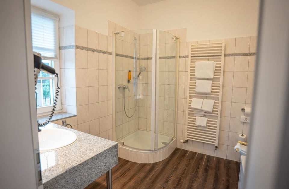 Standard Suite | Bathroom | Hair dryer, towels, soap, shampoo