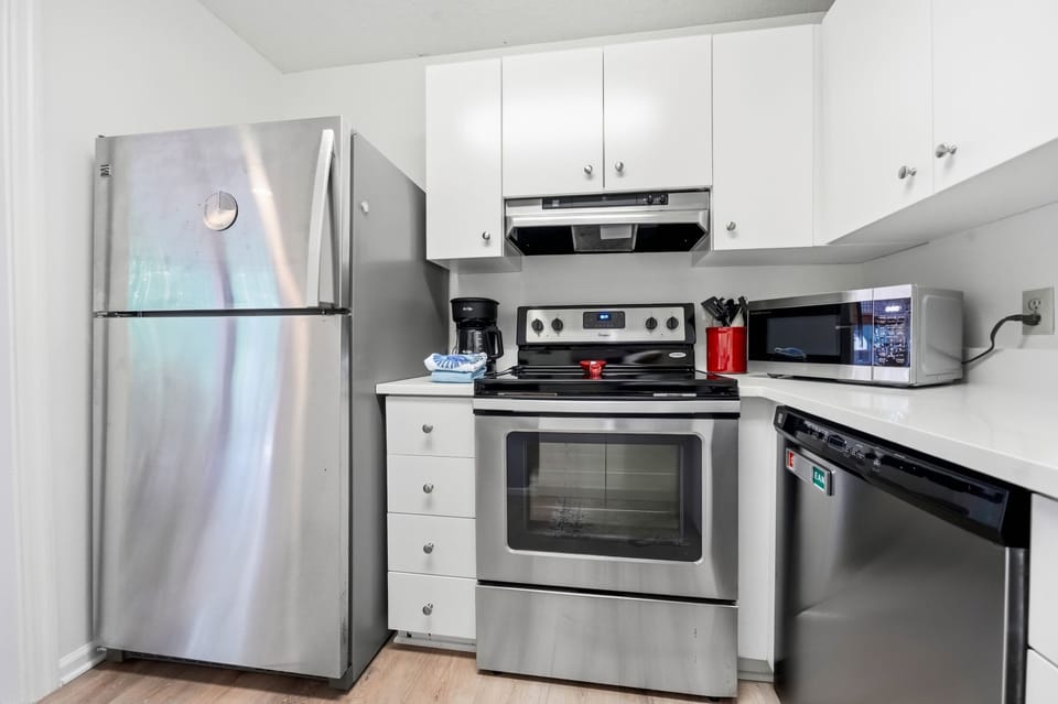 Kitchen with Full-Size Appliances - The full kitchen includes a refrigerator, electric range, microwave, dishwasher, toaster, drip coffee maker, and Keurig.