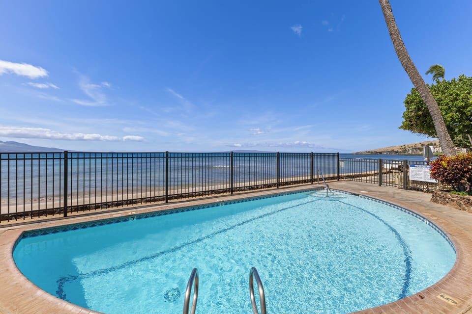 Picture yourself lounging poolside with the sparkling ocean just beyond, framed by swaying palms and vibrant island greenery. This beachfront oasis offers endless blue horizons and pure relaxation.
