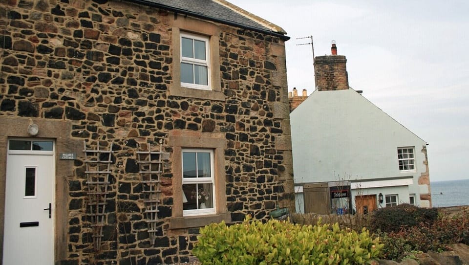 Charming stone exterior of Pegasus Cottage in coastal Craster.