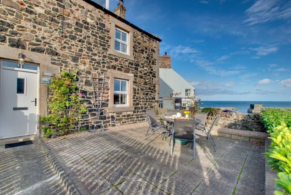 Outdoor seating with charming coastal views from Pegasus Cottage.