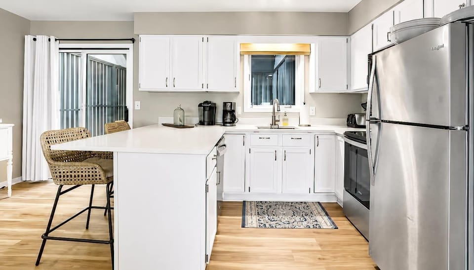 Fully equipped kitchen with stainless appliances and breakfast bar seating