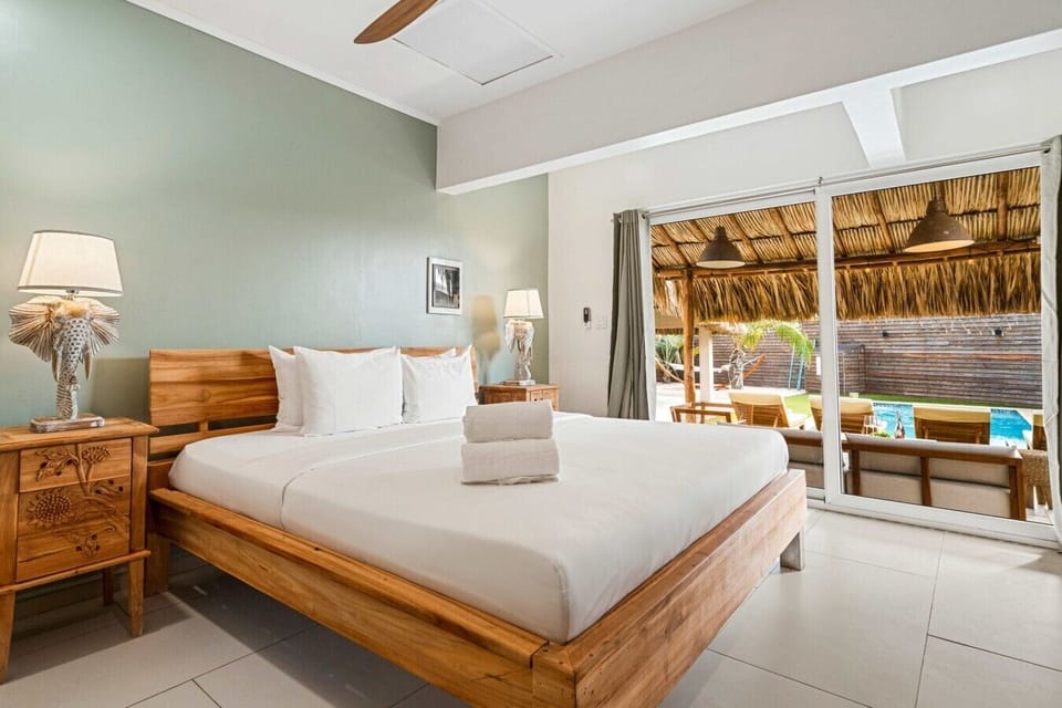Spacious interiors, beautiful views, and direct access to the poolside area make this bedroom especially inviting for guests who like an easy indoor-outdoor vacation flow