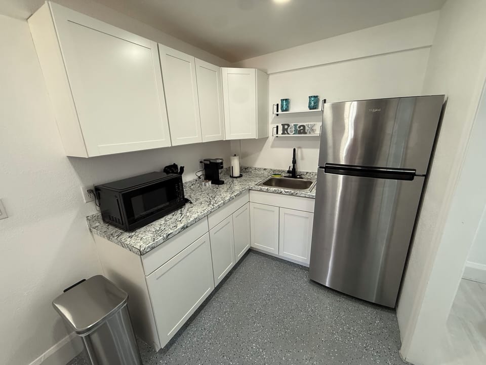 Bright updated kitchen with stainless appliances and coffee station